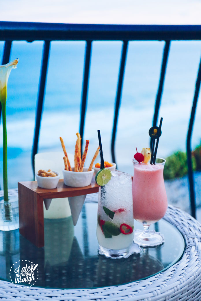 Complimentary bar snacks , Saffron Sunrise cocktail (vodka, Malibu, lime juice, lemon dice, kaffir lime leaves, whole lime, red chilli, soda, Rp 165,000) and Coconut Kiss mocktail (cherry, coconut, pineapple, grenadine, Rp 105,000)