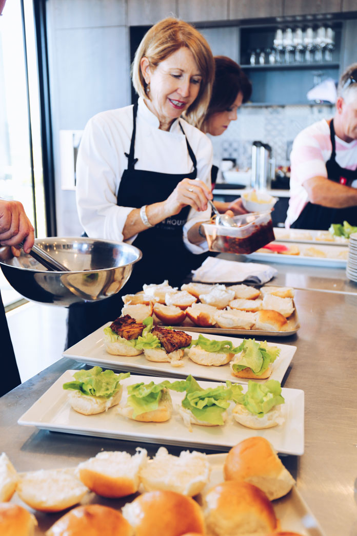 Annette demonstrating how to compile the pork belly sliders