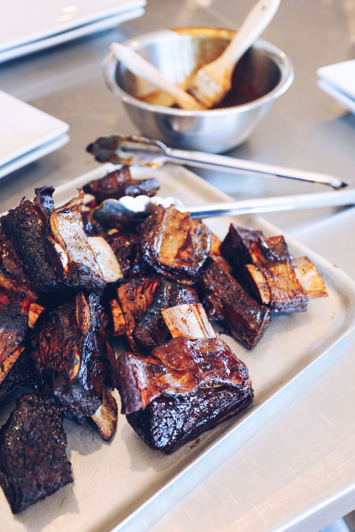 Twice cooked sticky soy glazed beef ribs ready to be served with cucumber and pickled garlic salad